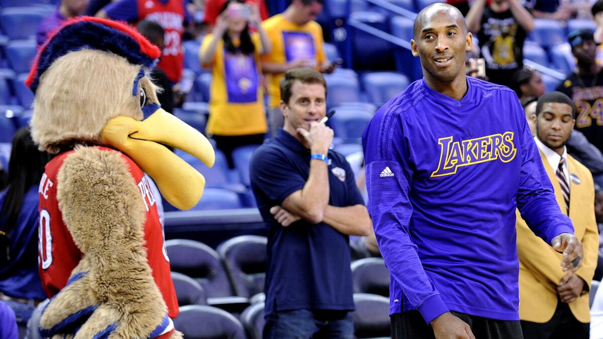 The New Orleans mascot pays Kobe Bryant a visit as he wamrs up for the game against the Pelicans on Friday night.