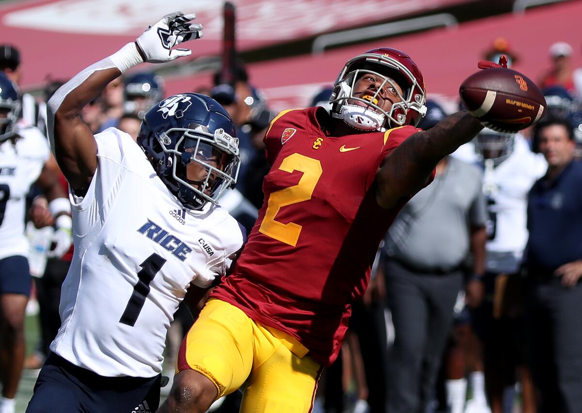 Rice cornerback Sean Fresch, left, is called for interference on a pass intended for USC wide receiver Brenden Rice.