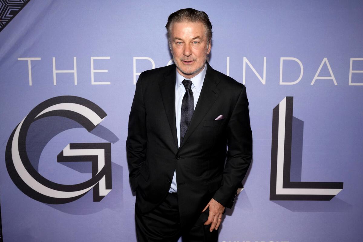 Alec Baldwin in business suit on a gala red carpet