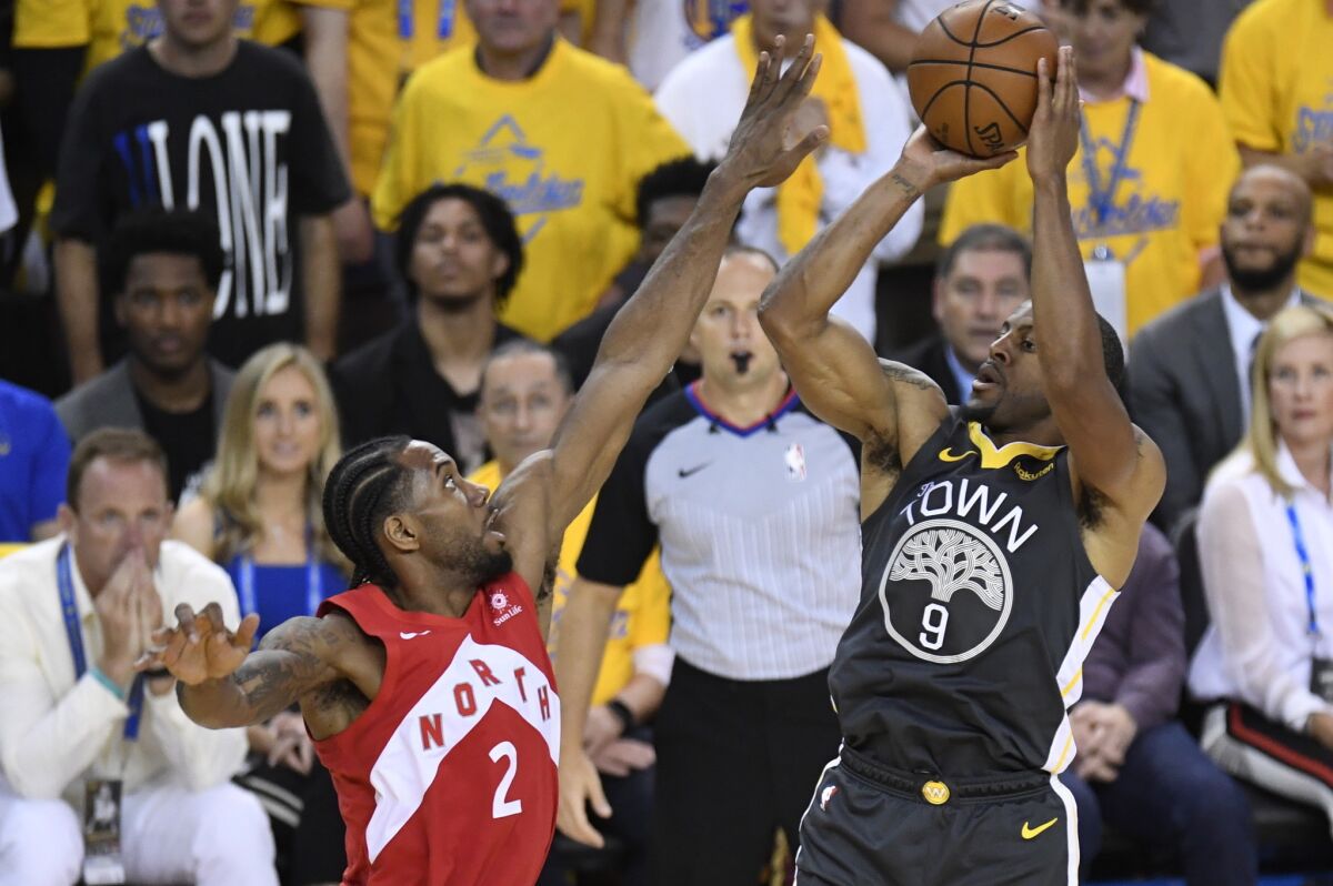Golden State Warriors forward Andre Iguodala (9) shoots over Toronto Raptors forward Kawhi Leonard (2) during the second half of Game 6 of the NBA Finals on Thursday in Oakland.