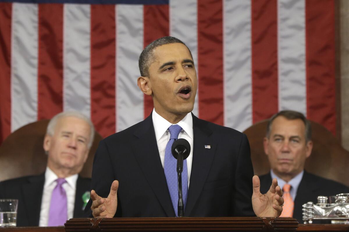 President Obama, flanked by Vice President Joe Biden and House Speaker John Boehner, gestures during his State of the Union address on Capitol Hill.
