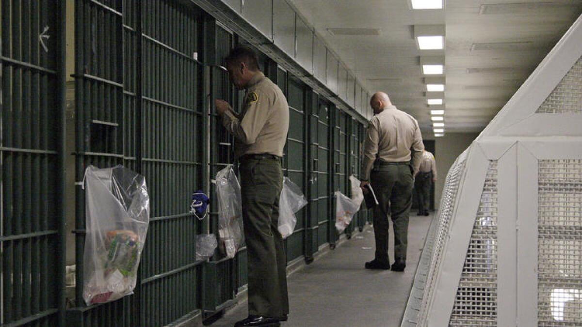 Los Angeles County sheriff's deputies inspect a cell block at Men's Central Jail in downtown Los Angeles.