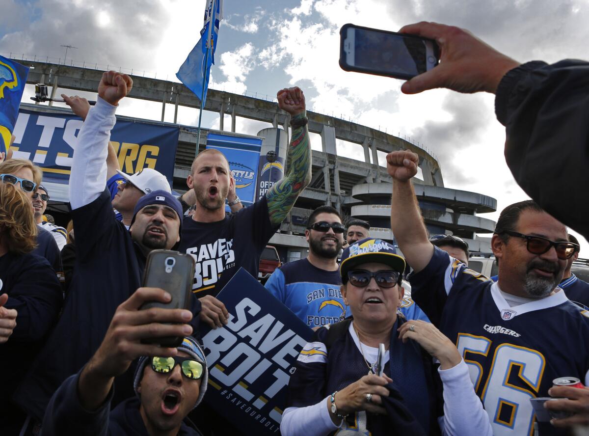 Former Charger player Nick Hardwick (wearing Save Our Bolts T-shirt) whips up the crowd at a rally outside Qualcomm Stadium before a meeting of a committee exploring a new stadium for the Chargers.