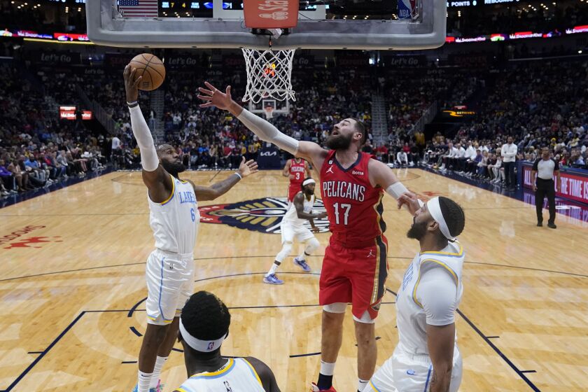 Los Angeles Lakers forward LeBron James (6) pulls down a rebound against New Orleans Pelicans center Jonas Valanciunas (17) in the first half of an NBA basketball game in New Orleans, Saturday, Feb. 4, 2023. (AP Photo/Gerald Herbert)