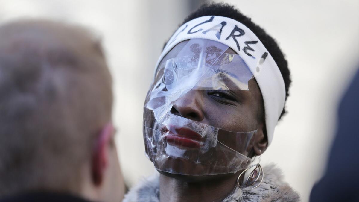 Therese Okoumou poses with clear tape on her face before her sentencing in New York on Tuesday.