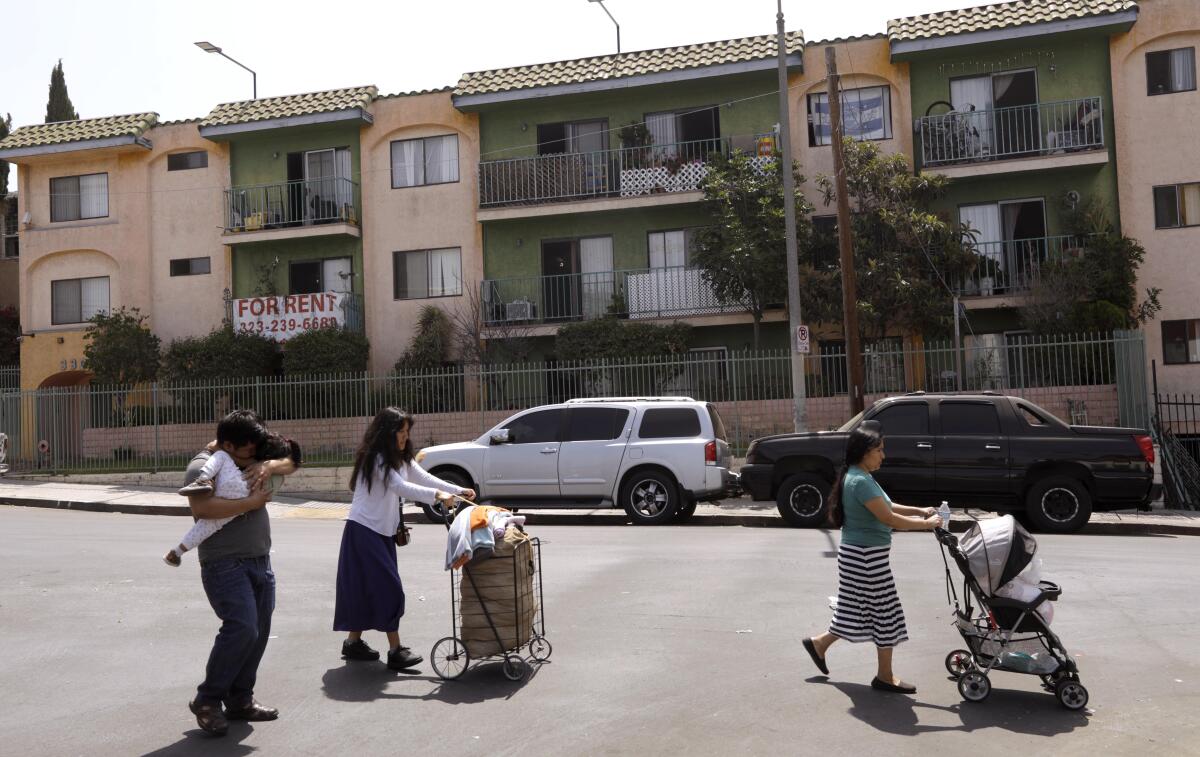 Pedestrians walk past the apartments at 330 S. Burlington Ave. in Westlake.