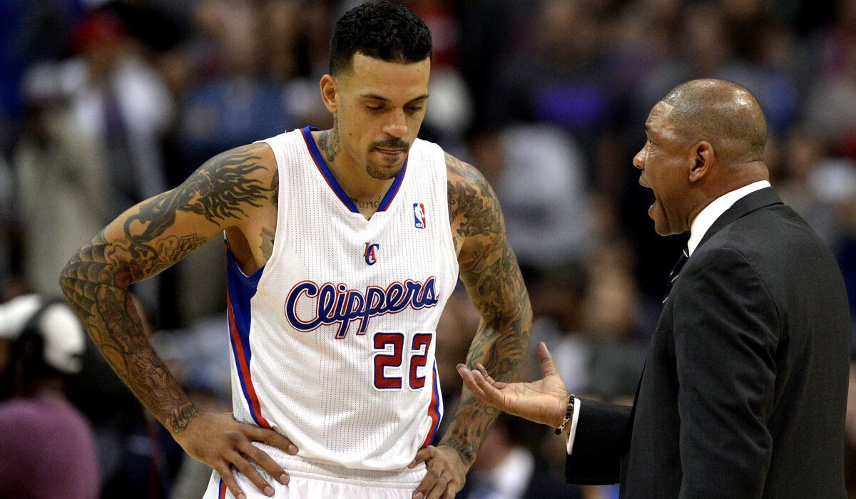 Clippers forward Matt Barnes listens to Coach Doc Rivers during a game last season.