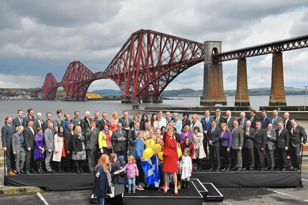 First Minister and leader of the Scottish National Party Nicola Sturgeon is joined by the newly elected members of Britain's Parliament in front of the Forth Rail Bridge in South Queensferry, Scotland.