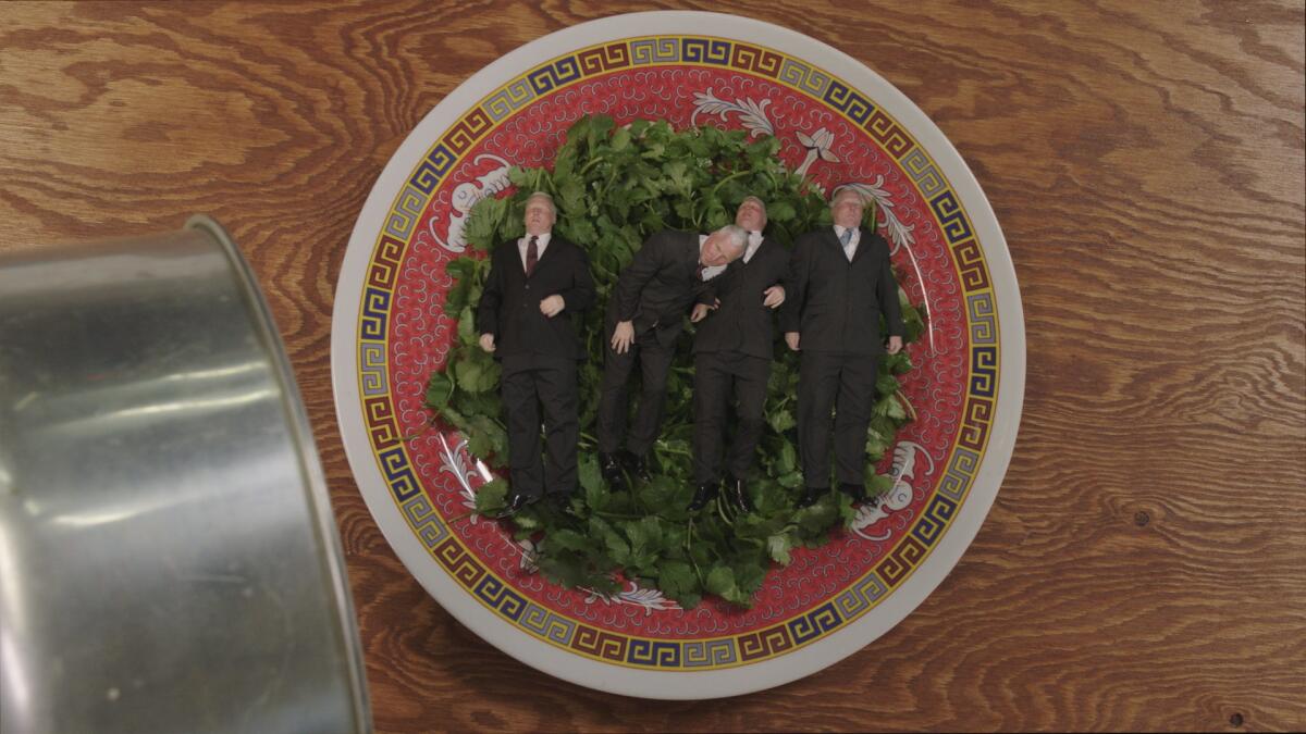 Four men in business suits lie on a platter of cilantro.