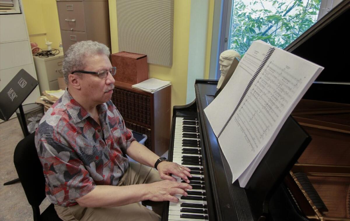 Anthony Davis playing the piano while looking at music sheets