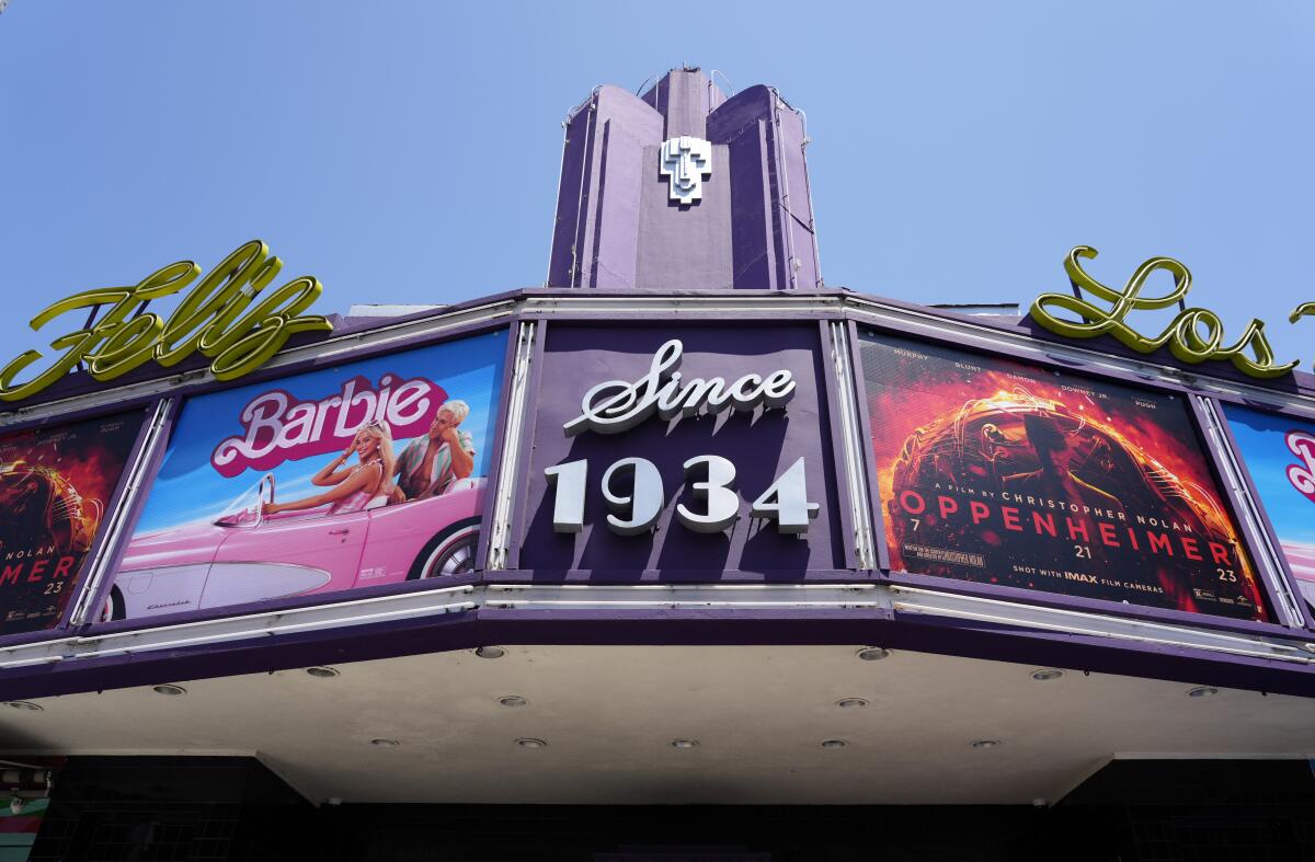 A classic movie-theater marquee with the posters for 'Barbie' and 'Oppenheimer.'