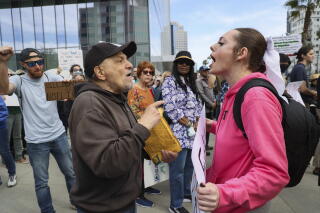 Alexis Linnea confronts a counter protester in front of City Hall.
