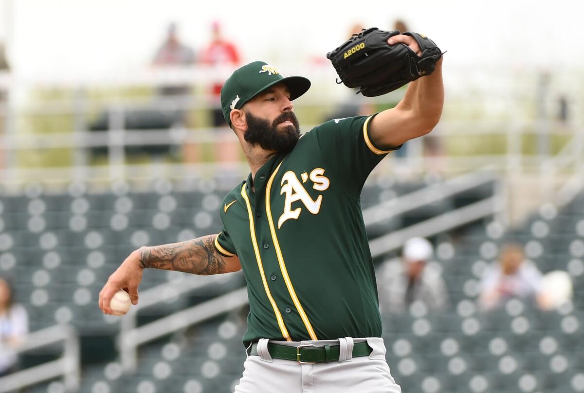 Oakland Athletics pitcher Mike Fiers delivers a first inning pitch against the Cincinnati Reds during a spring training game at Goodyear Ballpark on Feb. 28 in Goodyear, Ariz.