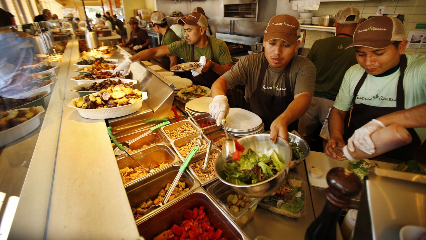 Tender Greens operates 17 locations, all in California. Above, Tender Greens workers prepare lunch for customers in Santa Monica last month.
