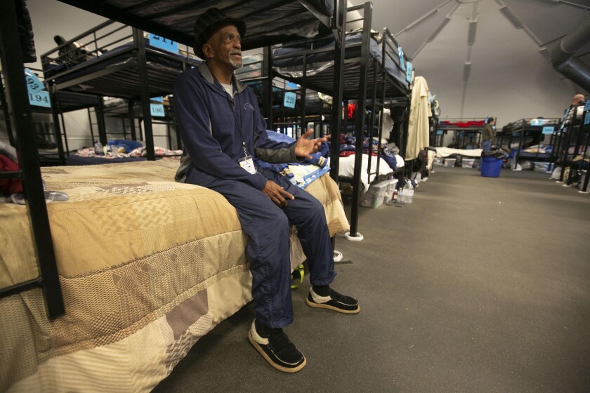 In this photo from February 2020, Jerome Morrison sits on his bed at the homeless shelters in downtown San Diego. 
