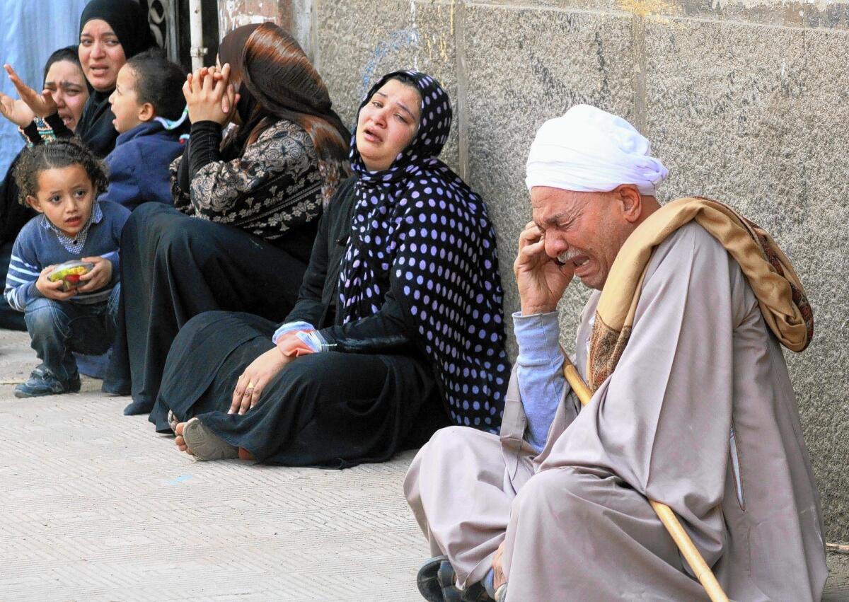 Relatives of defendants sentenced to death in Egypt cry as they sit outside the courthouse in Minya. The court ordered the execution of 529 Morsi supporters after only two hearings. The unprecedented verdict, amid an extensive crackdown on Morsi supporters, was condemned by human rights groups.