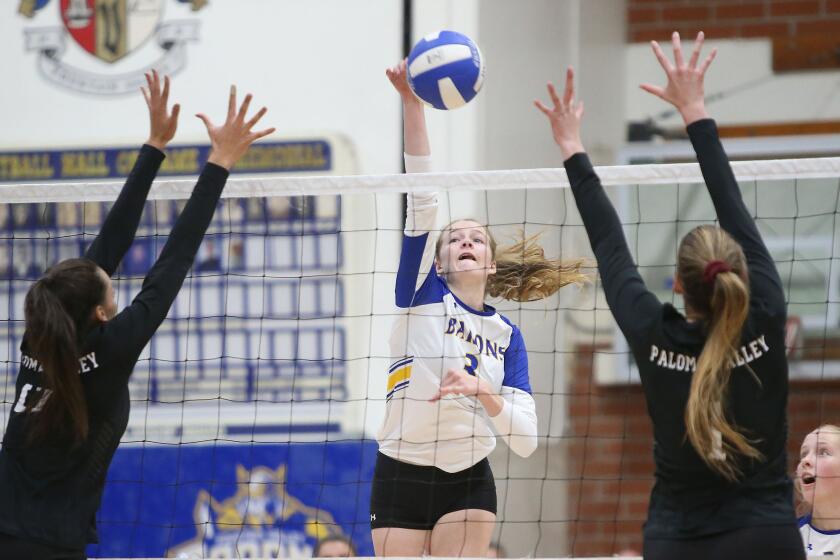 Fountain Valley's Juliette Bokor hits a ball past two Paloma Valley blockers in the quarterfinals of the CIF Southern Section Division 3 playoffs on Wednesday.