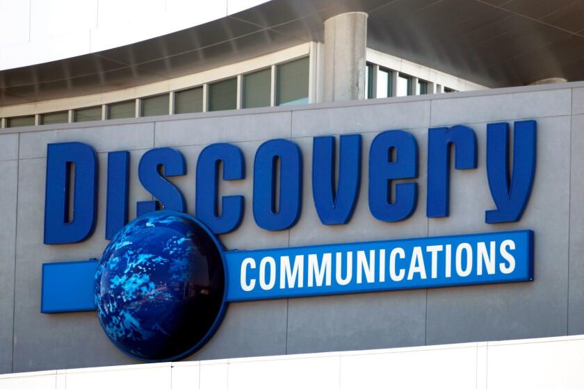 FILE - This Sept. 1, 2010 file photo shows the Discovery Communications networks headquarters building sign in Silver Spring, Md. Discovery Communications is buying media company Scripps Networks Interactive Inc. in a cash-and-stock deal worth $14.6 billion that will help it reach more female viewers, announced Monday, July 31, 2017. (AP Photo/Manuel Balce Ceneta, File)