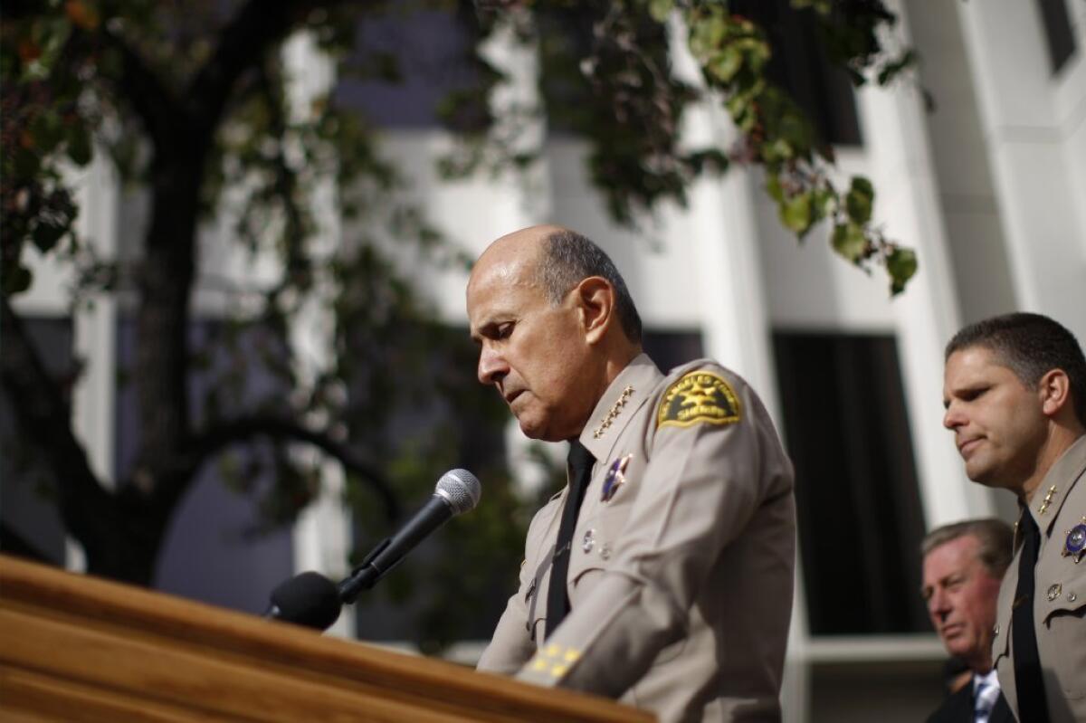 Los Angeles County Sheriff Lee Baca, who had said he would run for a fifth term, is seen on Tuesday announcing his resignation.