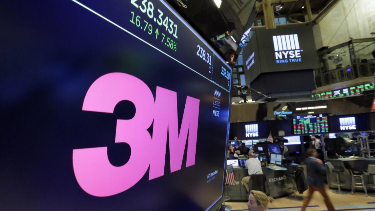 The logo for 3M appears on a screen above the trading floor of the New York Stock Exchange.