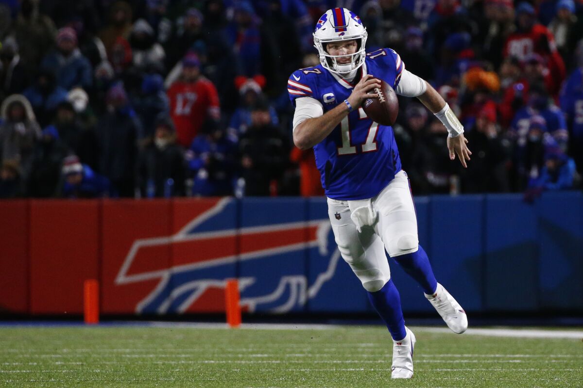 Buffalo Bills quarterback Josh Allen runs with the ball.