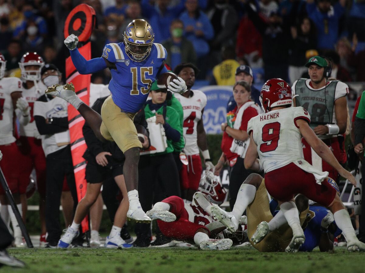 UCLA linebacker Jordan Genmark Heath leaps over the Fresno State defense after recovering a fumble 