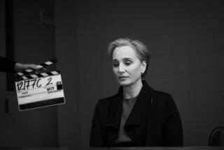 A black and white image of an actress next to a slate.