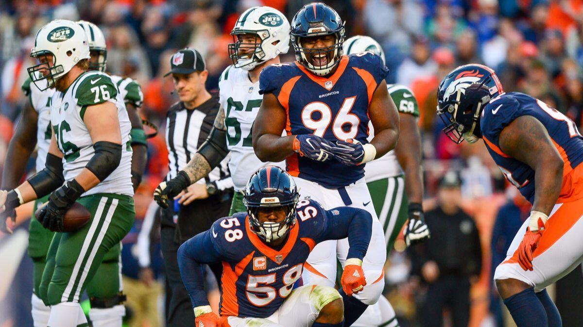 Denver Broncos outside linebacker Von Miller (58) celebrates along with Shelby Harris (96) after a sack against the New York Jets in the third quarter on Sunday.