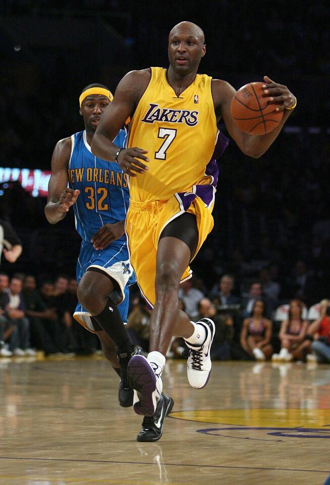 Gallardo, Alex -- - LOS ANGELES, CA - DEC. 1, 2009: Lakers Lamar Odom (7) drives to the basket against the New Orleans Hornets Julian Wright (32) in the fourth quarter in a NBA basketball game DEC. 1, 2009 at the Staples Center. (Photo by Alex Gallardo/Los Angeles Times)