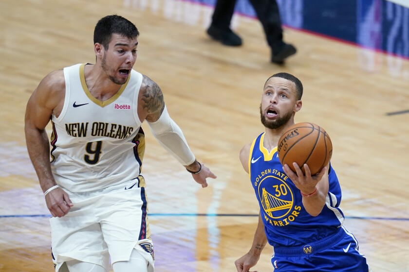 Golden State Warriors guard Stephen Curry (30) goes to the basket against New Orleans Pelicans center Willy Hernangomez (9) in the first half of an NBA basketball game in New Orleans, Monday, May 3, 2021. (AP Photo/Gerald Herbert)