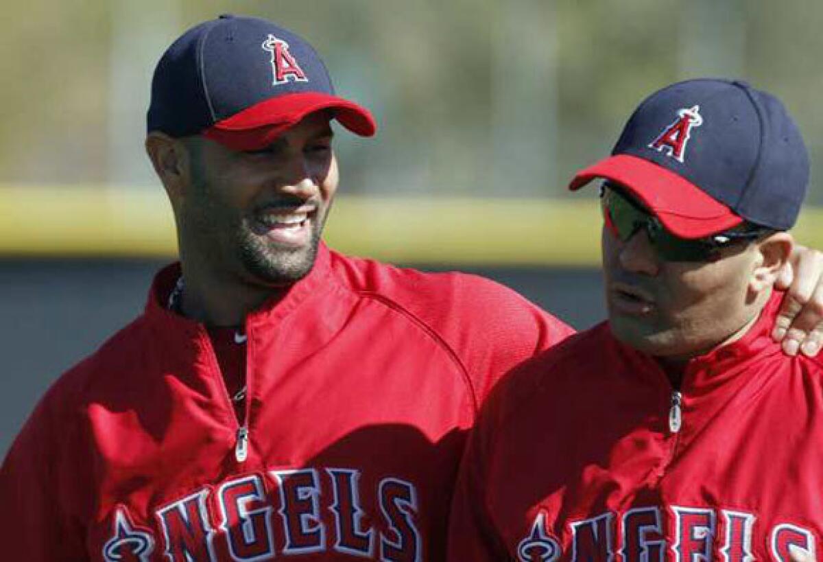 Albert Pujols, left, and Kendrys Morales share a laugh during spring training.