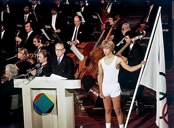 Juan Antonio Samaranch, president of the International Olympic Committee, makes the opening address at the 11th Olympic Congress in Baden-Baden, West Germany, in 1981. An unidentified athlete holds the Olympic flag. Samaranch died Wednesday in Barcelona at age 89. See full story
