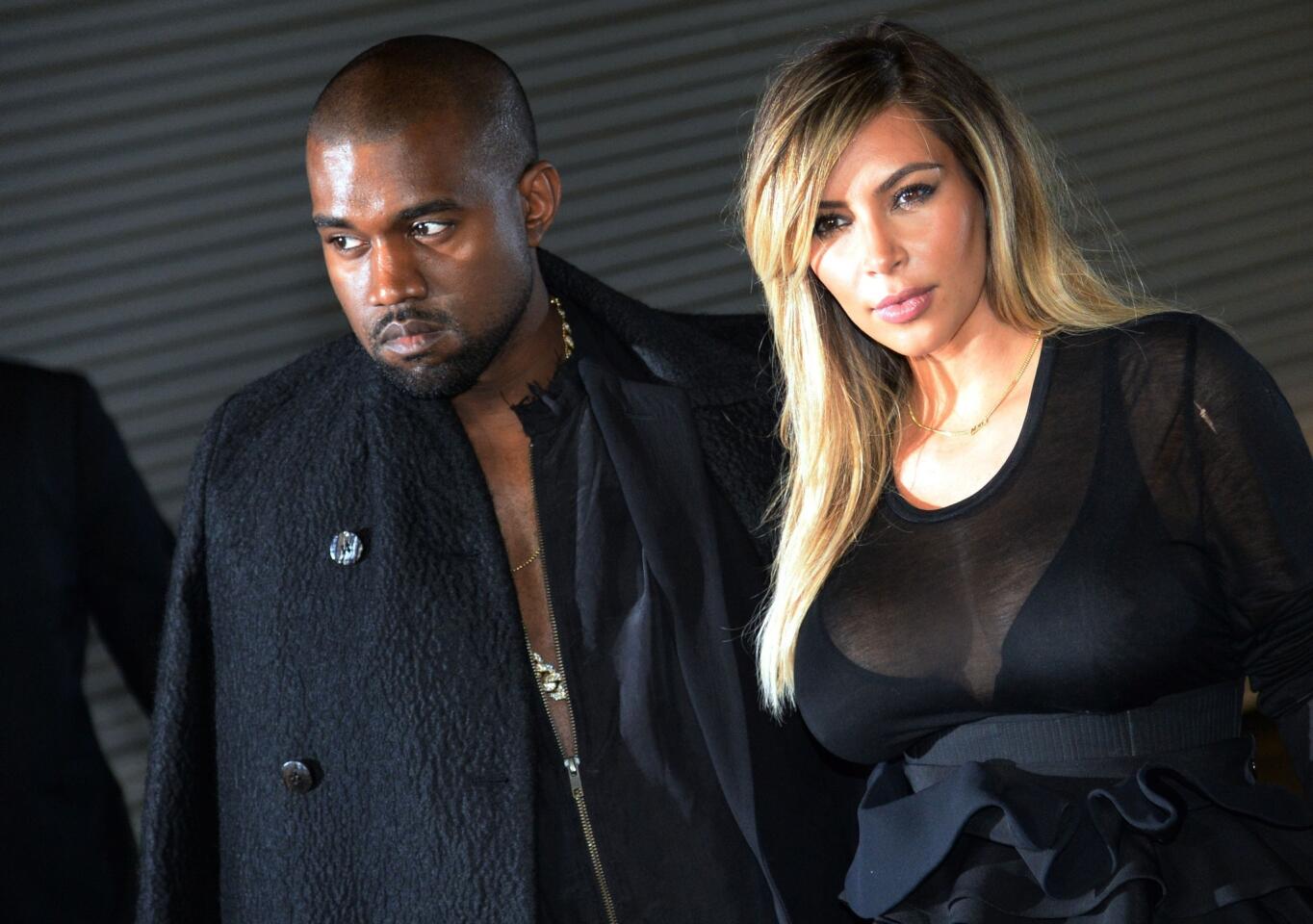 Musician Kanye West and girlfriend Kim Kardashian at the Givenchy 2014 spring-summer ready-to-wear collection fashion show on Sept. 29, 2013, in Paris.