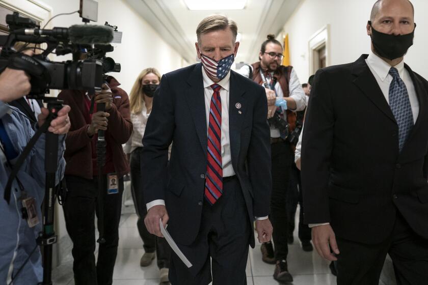 Rep. Paul Gosar, R-Ariz., leaves his office as the House of Representatives prepares to vote on a resolution to formally rebuke him for tweeting an animated video that depicted him striking Rep. Alexandria Ocasio-Cortez, D-N.Y., with a sword, on Capitol Hill in Washington, Wednesday, Nov. 17, 2021. In addition to the official censure, House Democrats want to oust him from his seats on the House Oversight Committee and the Natural Resources Committee. (AP Photo/J. Scott Applewhite)