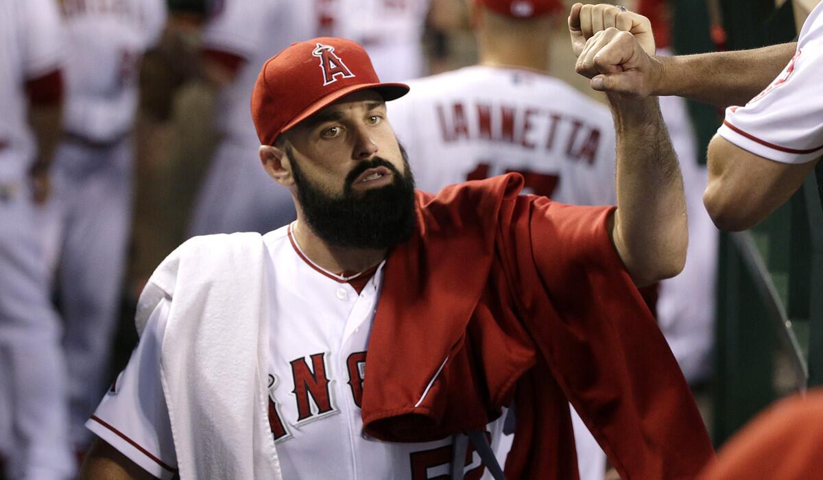 Angels starting pitcher Matt Shoemaker gets a fist bump from a coach before his last start on Monday. He would eventually exit the game with a strained muscle.