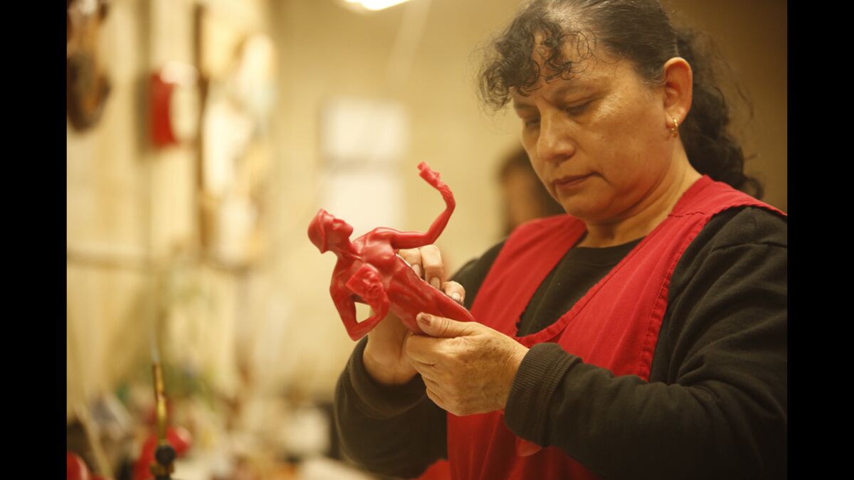 Blanca Lemus prepares the wax statuettes to be used to create the final bronze product.