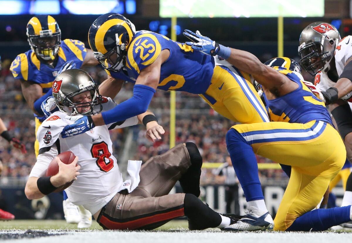 St. Louis safety T.J. McDonald, top, sacks Tampa Bay Buccaneers quarterback Mike Glennon during the Rams' 23-13 win on Dec. 22. The Washington Redskins' dismal season is good news for the Rams.