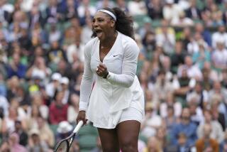 Serena Williams of the US celebrates after winning a point against France's Harmony Tan
