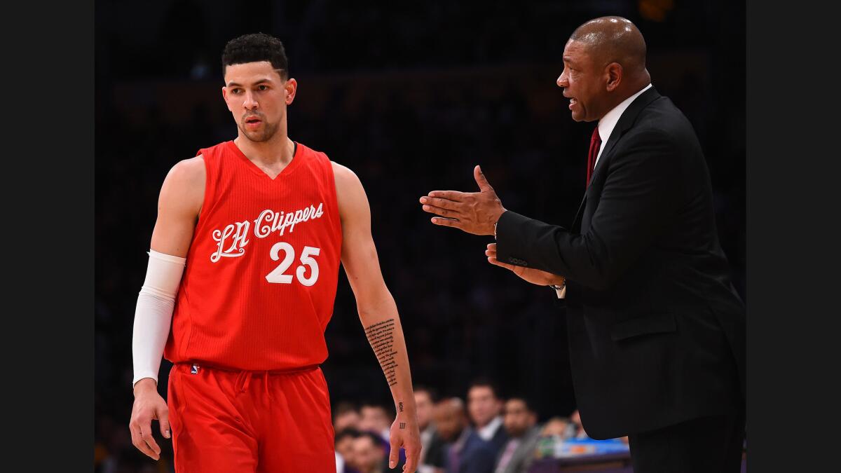 Clippers Coach Doc Rivers talks to guard Austin Rivers during a Dec. 25 game against the Lakers at Staples Center.