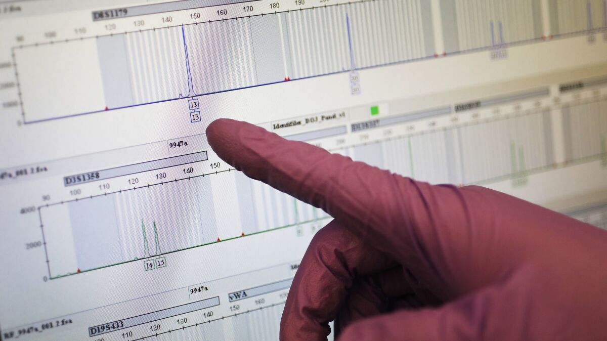 Los Angeles Police Department criminalist Forrest Yumori points to a DNA profile generated by a genetic analyzer similar to the one used to identify the Golden State Killer.