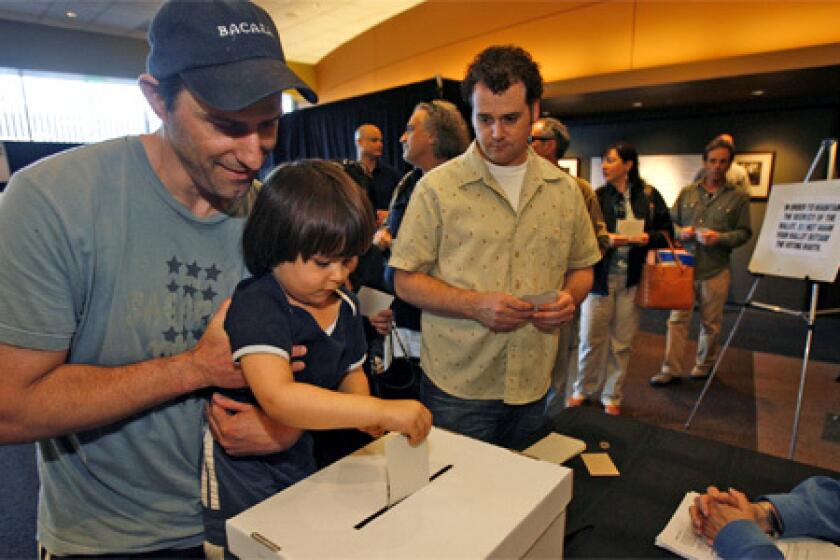 FAMILY MATTERS: Writer Greg Fields lets 3-year-old son Caelan cast his ballot at the Writers Guild of America Theater.