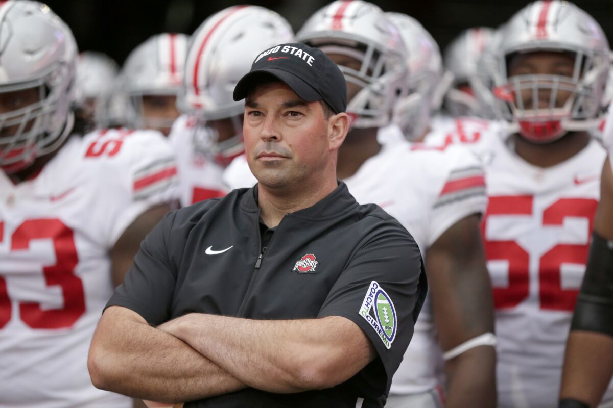 Ohio State coach Ryan Day waits with his players before taking the field