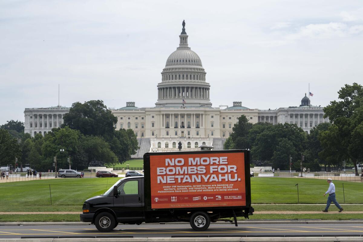 A truck with a sign reading No More Bombs for Netanyahu in front of the Capitol in Washington.