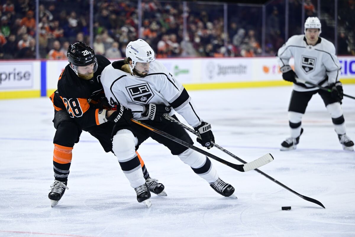 The Flyers' Claude Giroux, left, and Kings' Phillip Danault battle for the puck Jan. 29, 2022.