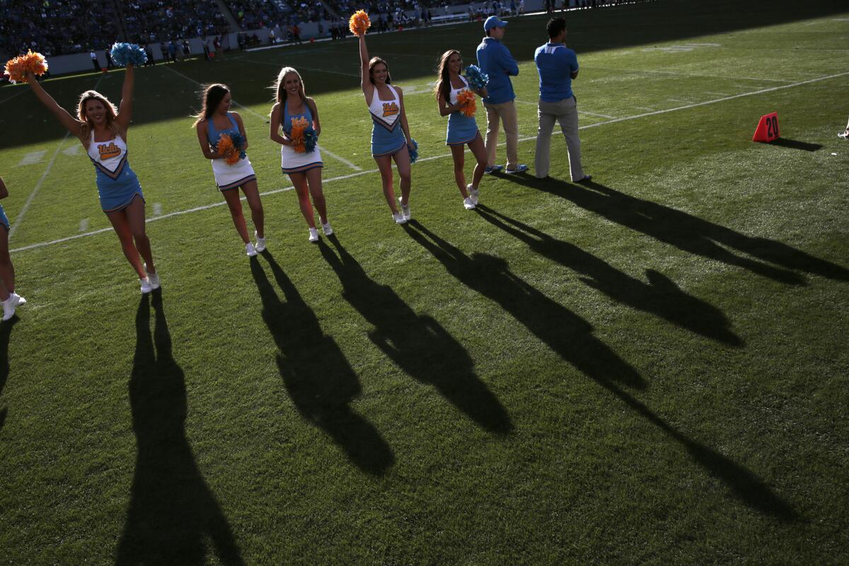 UCLA cheerleaders cheer from the sideline during the Bruins' annual spring football game on April 26.