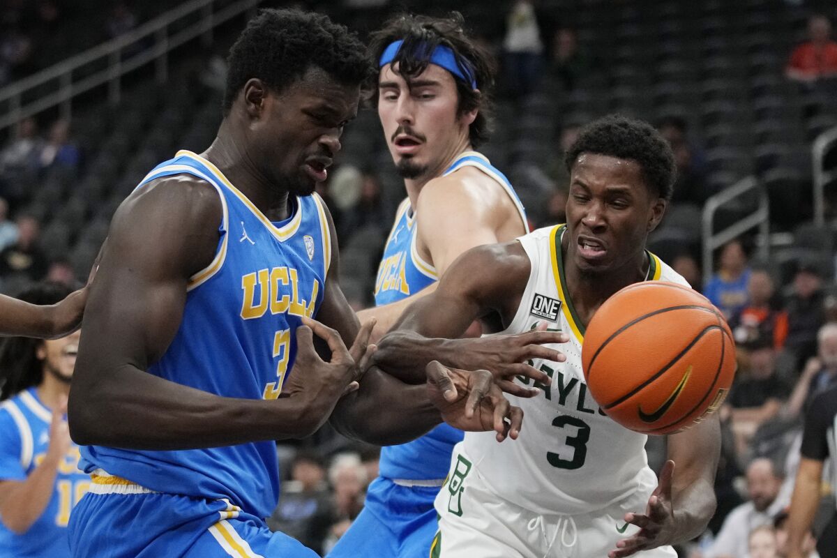 UCLA's Adem Bona, left, and Baylor's Dale Bonner battle for the ball during the second half Sunday.