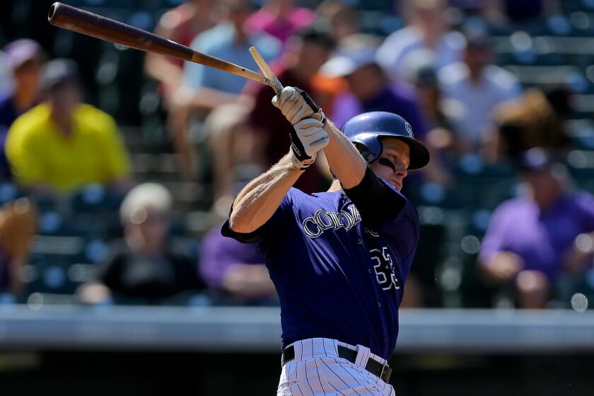 Colorado's Justin Morneau was out of the lineup Saturday after suffering a strained muscle in the left side of his rib cage Friday.
