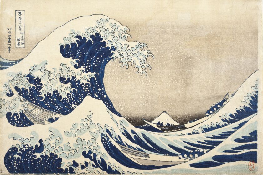 A wood block print shows a giant wave in shades of blue carrying a boat. In the distance, rendered small, is Mt. Fuji.