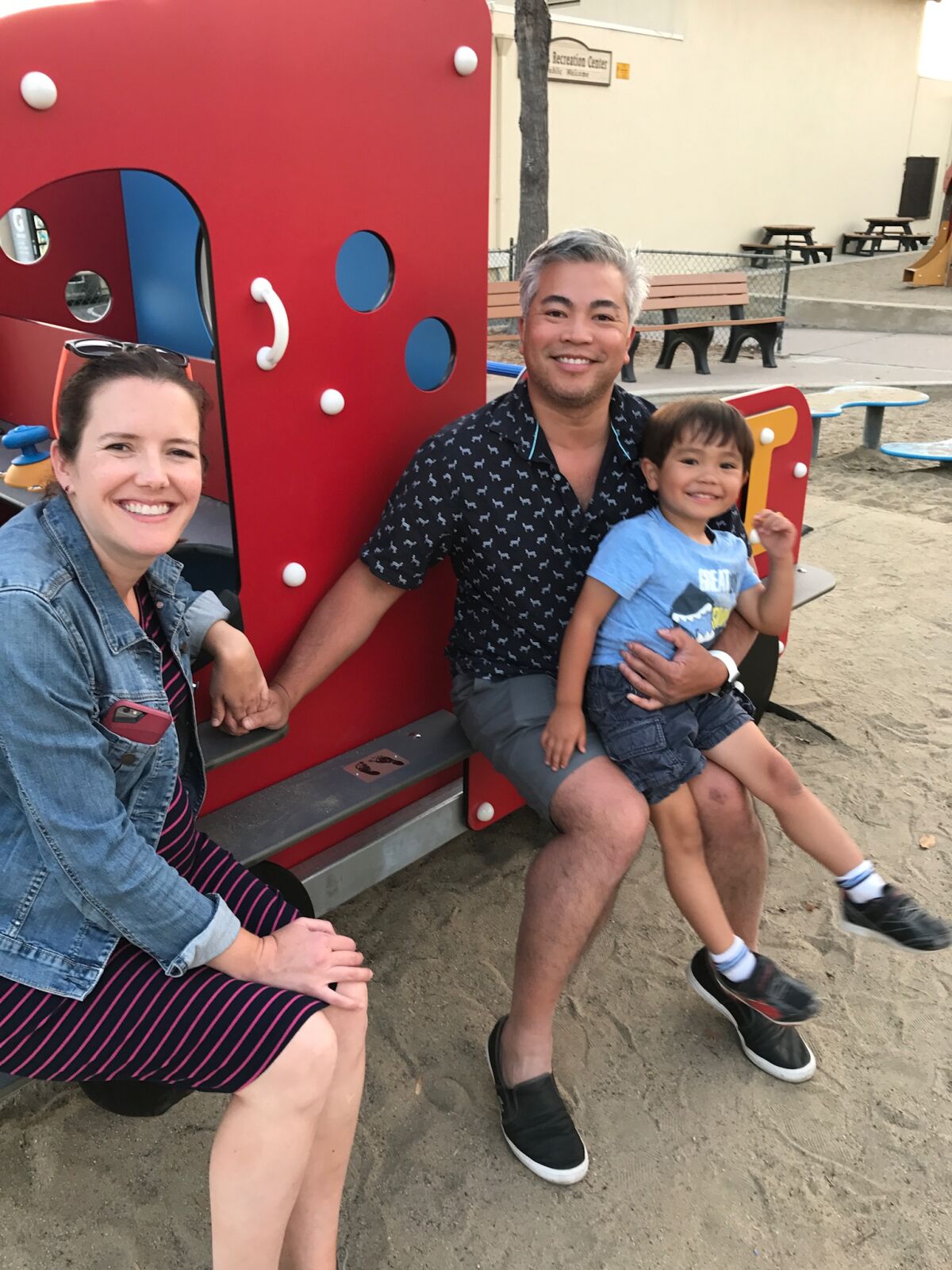 Katherine and Chris Pham with their son Carlton in July 2017, after Baby Jane’s fire truck was installed at La Jolla Rec Center.