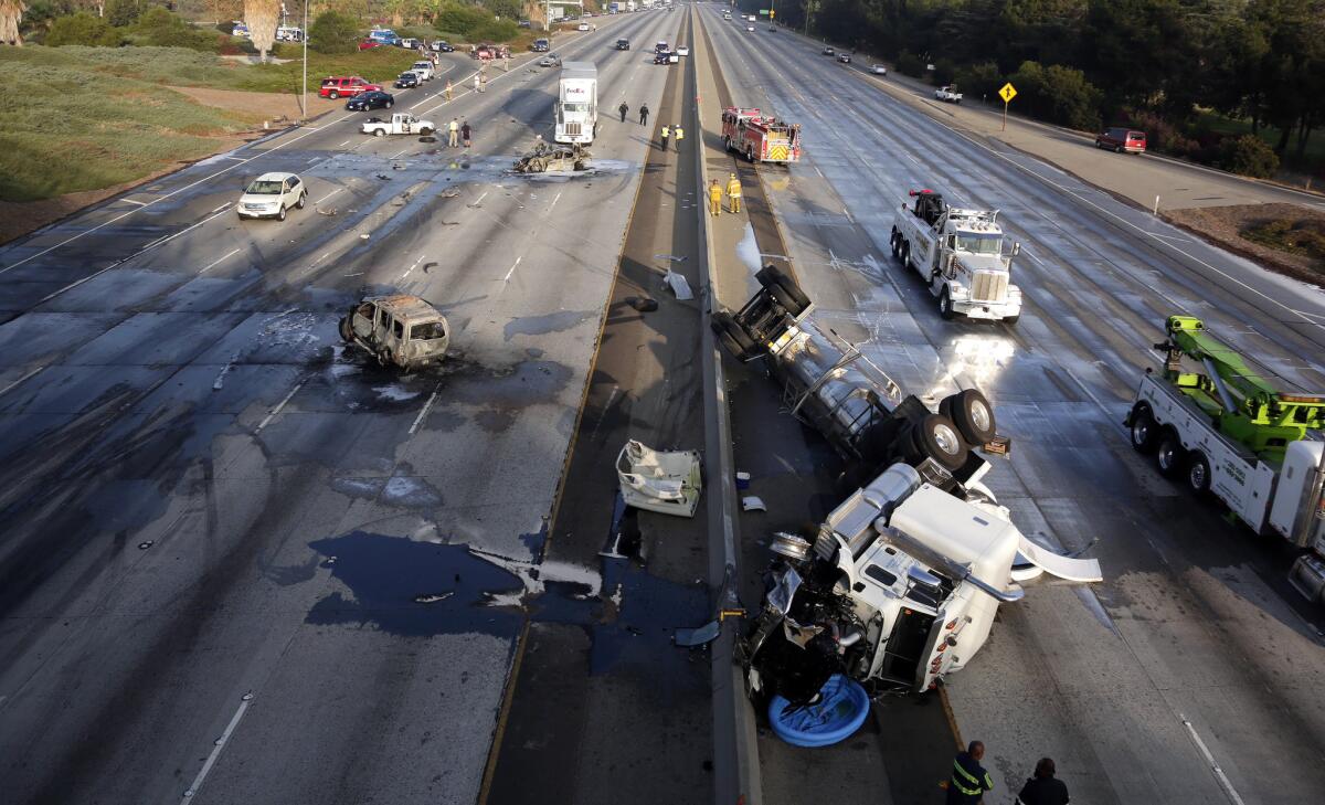 Wreckage lies on both sides of the center divider after a crash in which a milk tanker overturned on the 60 Freeway near South El Monte.